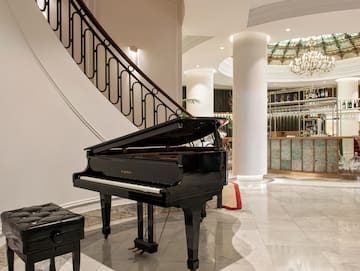 a piano in a room with a staircase