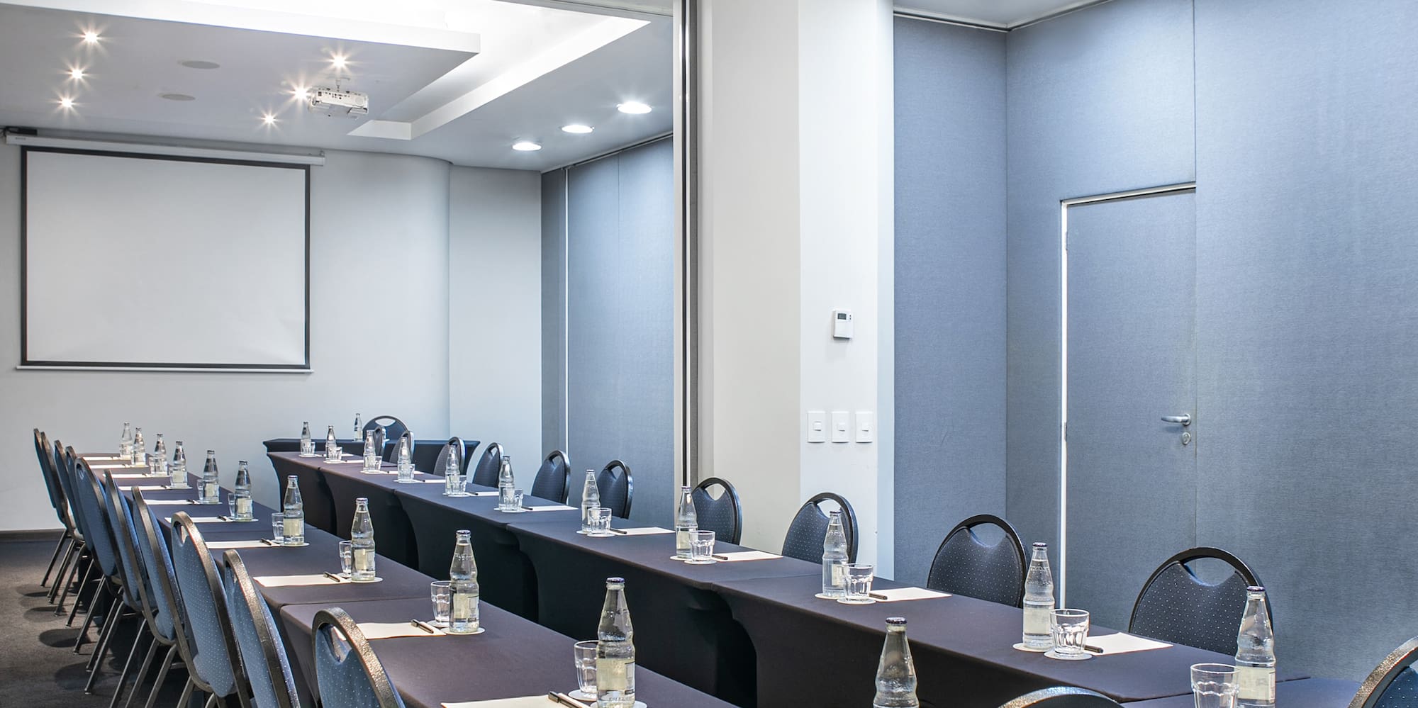 a room with long tables and chairs