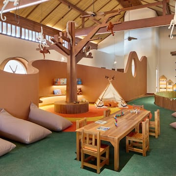 a room with a table and chairs and a tent