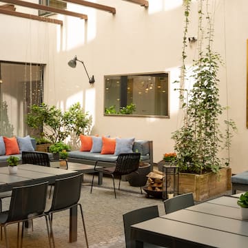 a patio area with tables and chairs