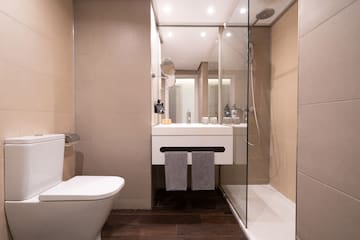 a bathroom with a glass shower door