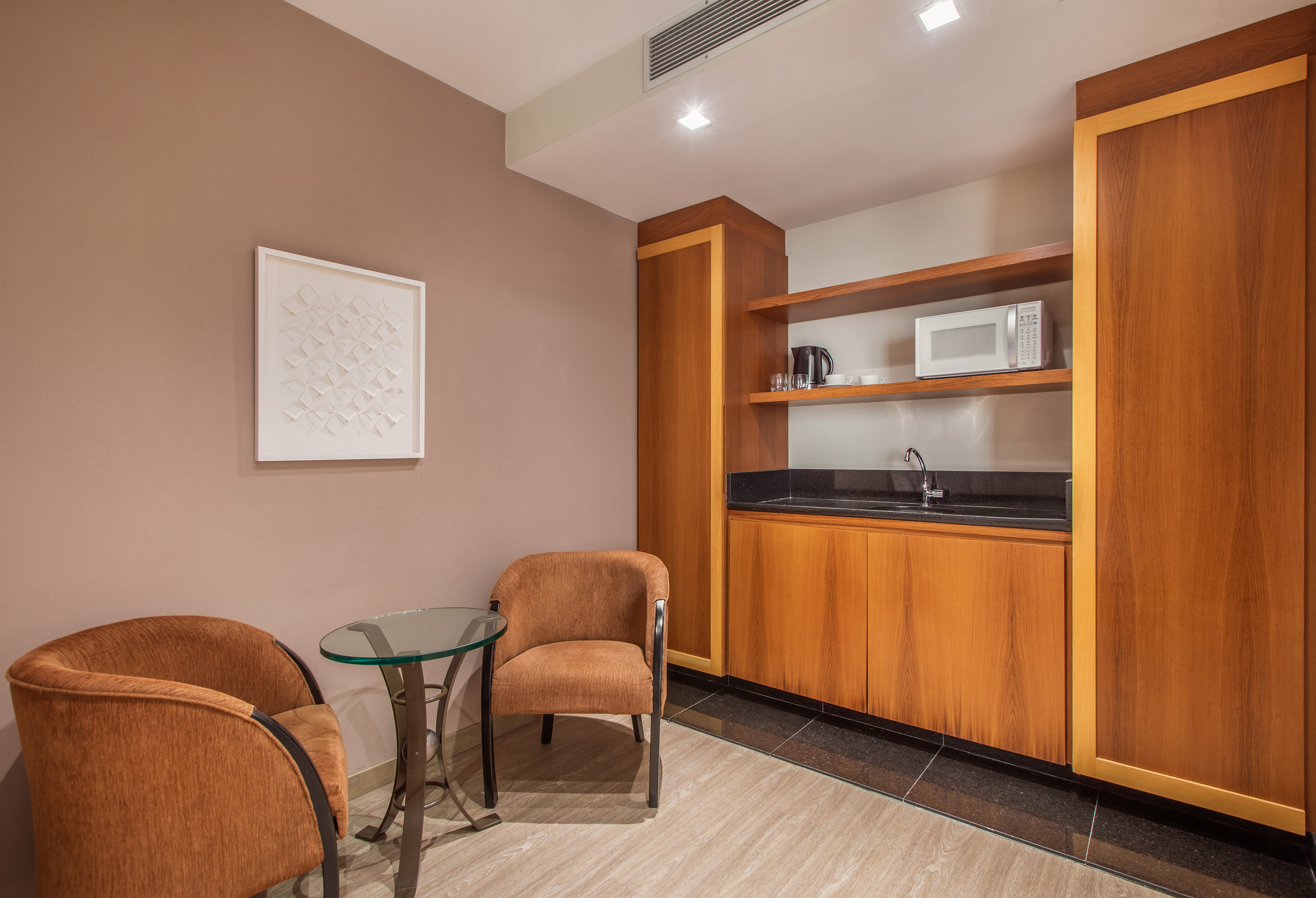 a room with a glass table and chairs