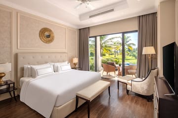 a bedroom with a large bed and a chair