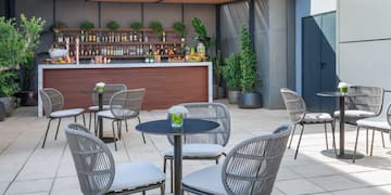 a patio with chairs and tables