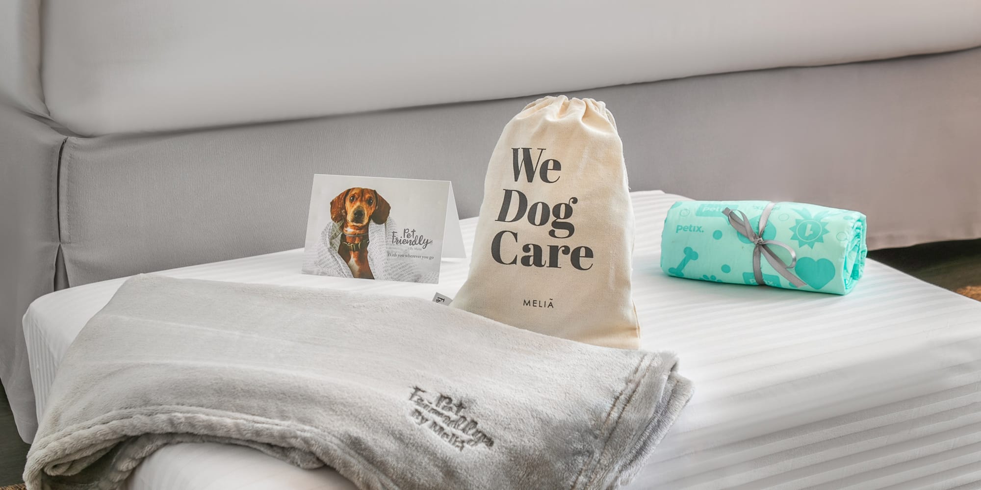 a dog bed with a dog food bowl and a dog food bowl