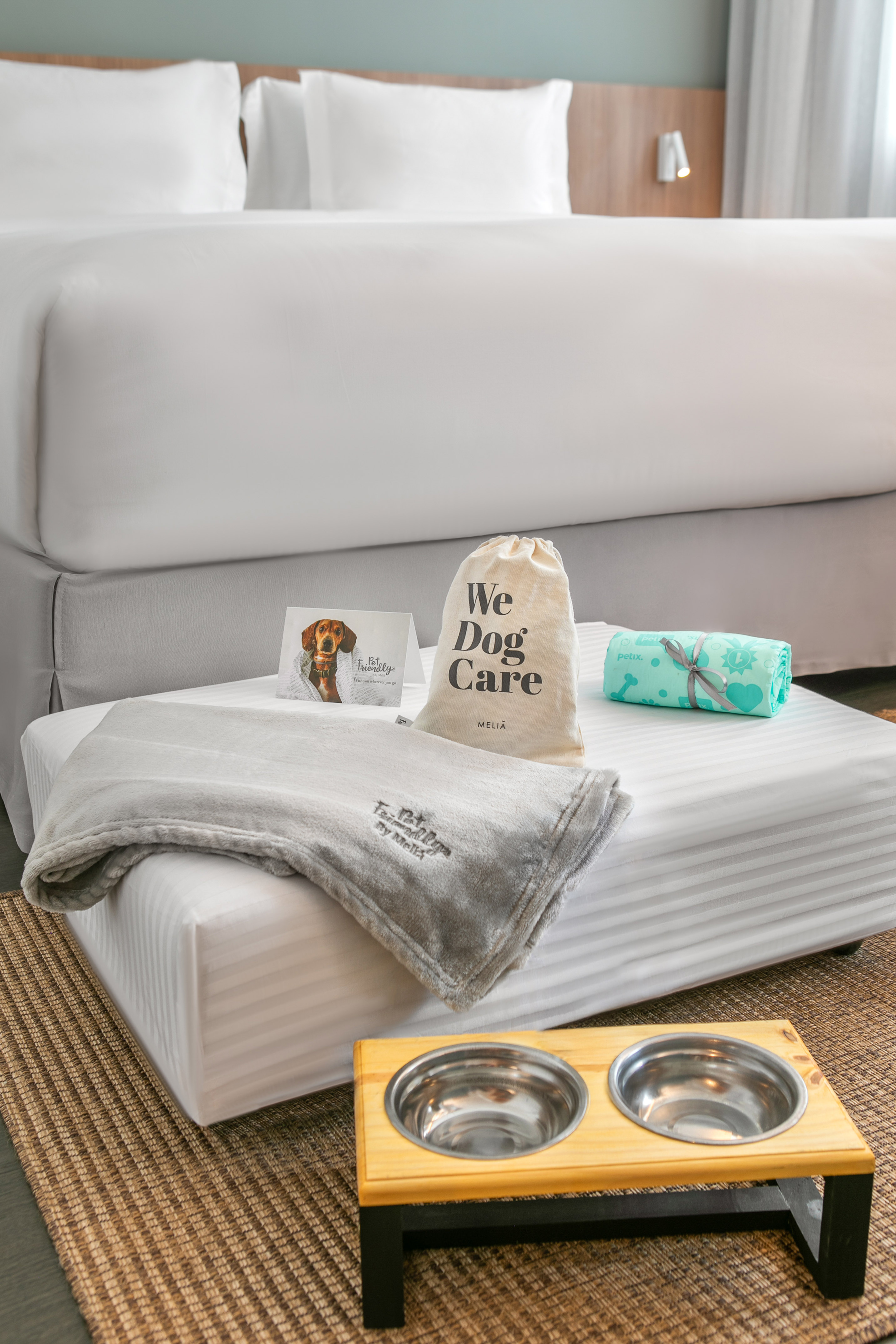 a dog bed with a dog food bowl and a dog food bowl