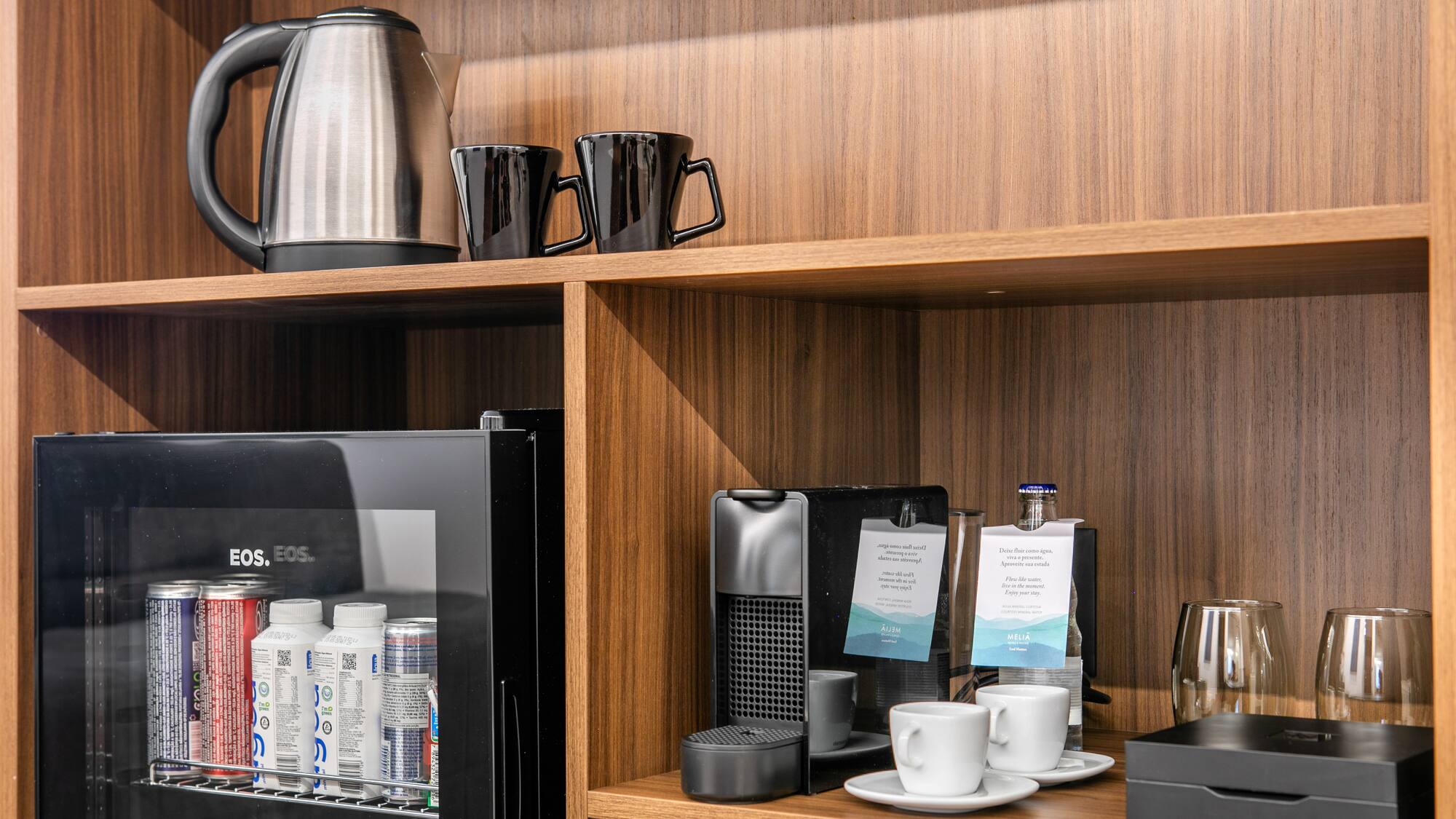 a shelf with coffee cups and other items on it