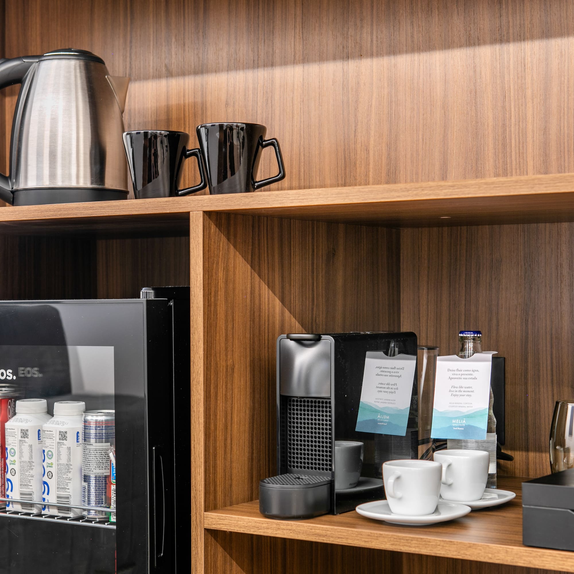 a shelf with coffee cups and other items on it