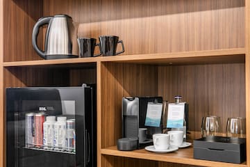 a shelf with coffee cups and other items on it