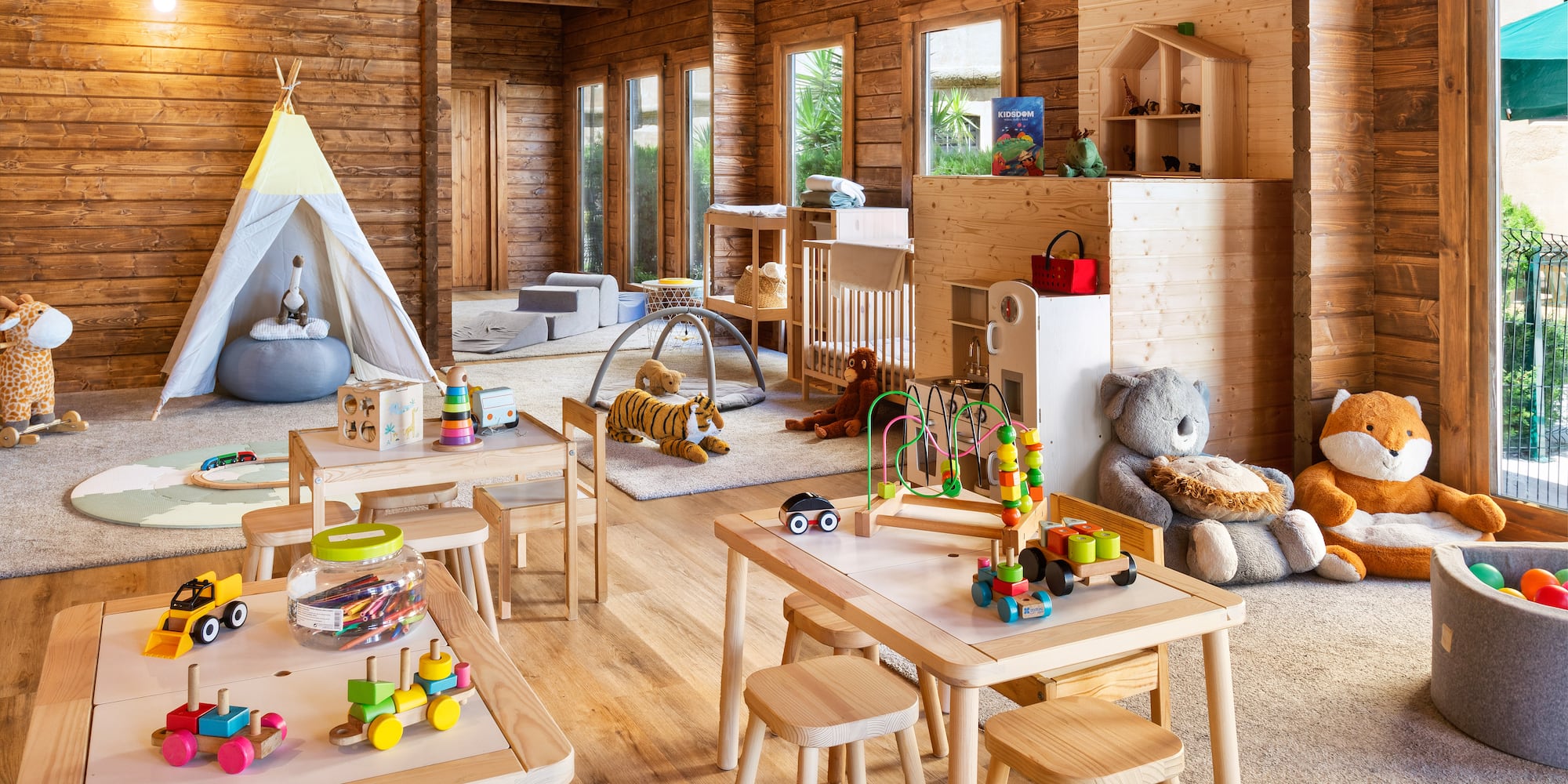 a room with wooden walls and tables and toys
