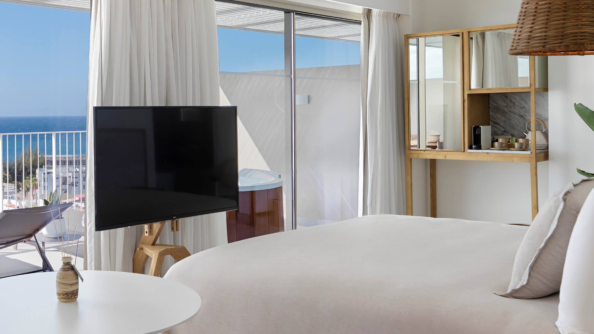 a bedroom with a television and a window