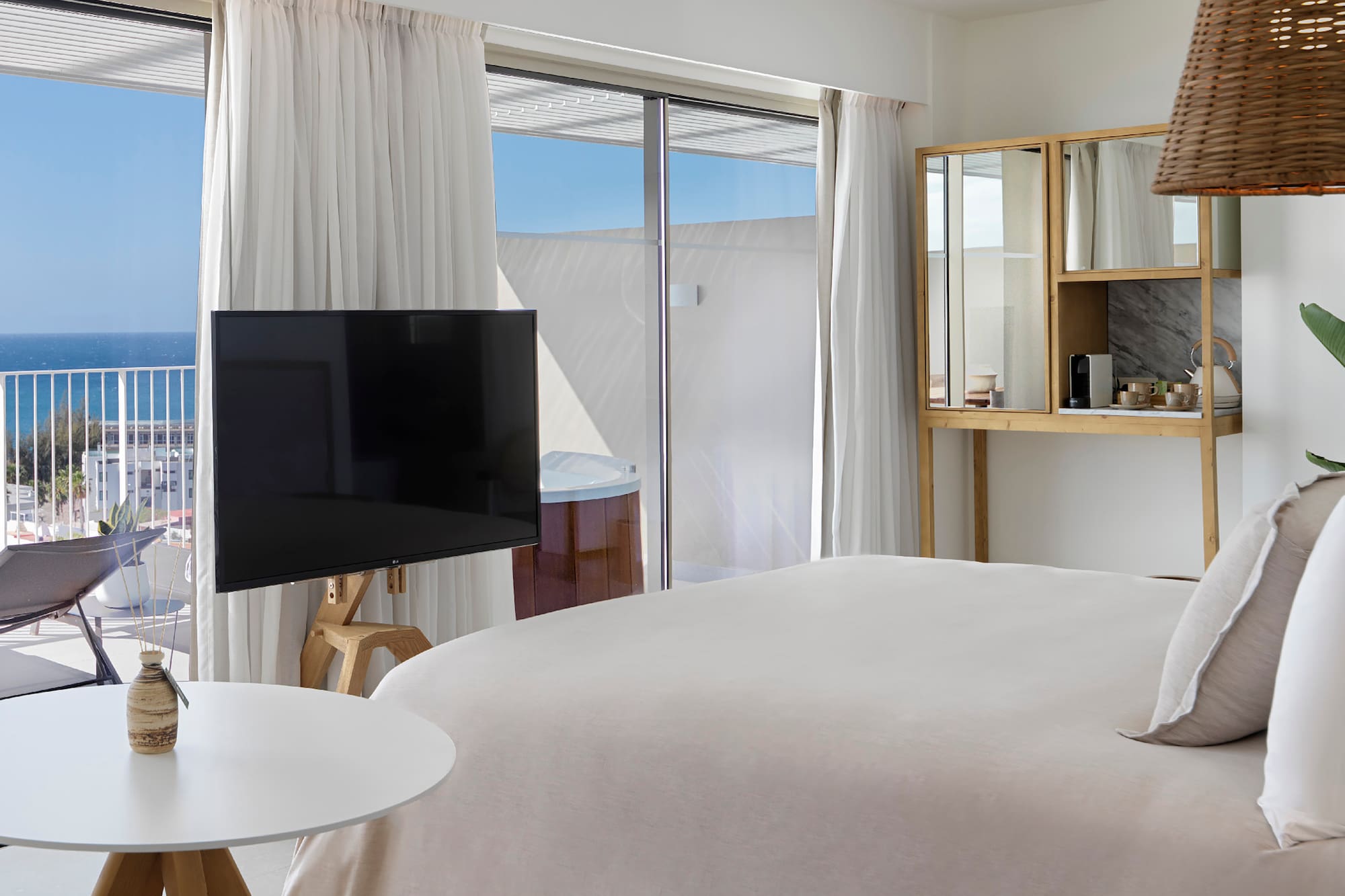 a bedroom with a television and a window