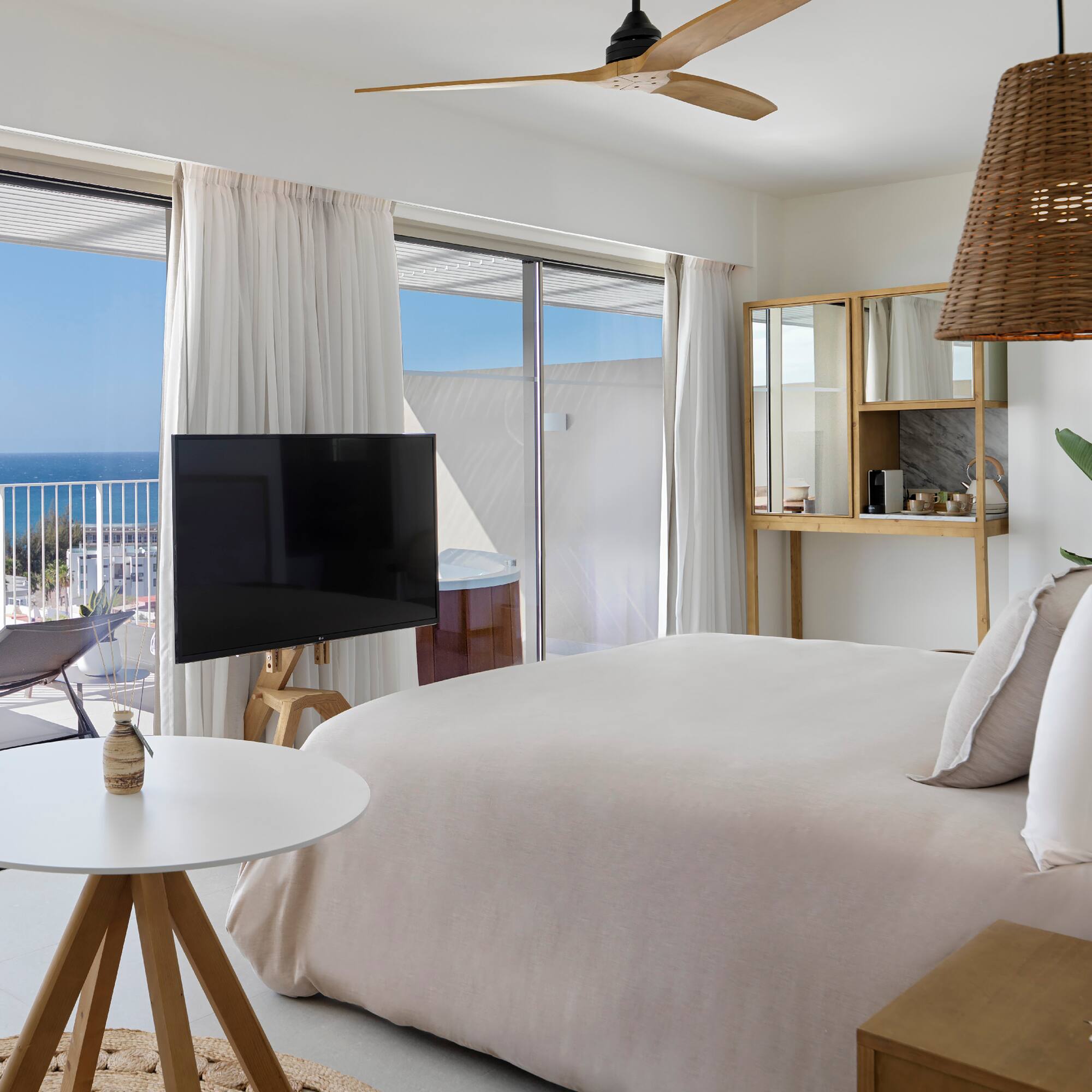 a bedroom with a television and a window