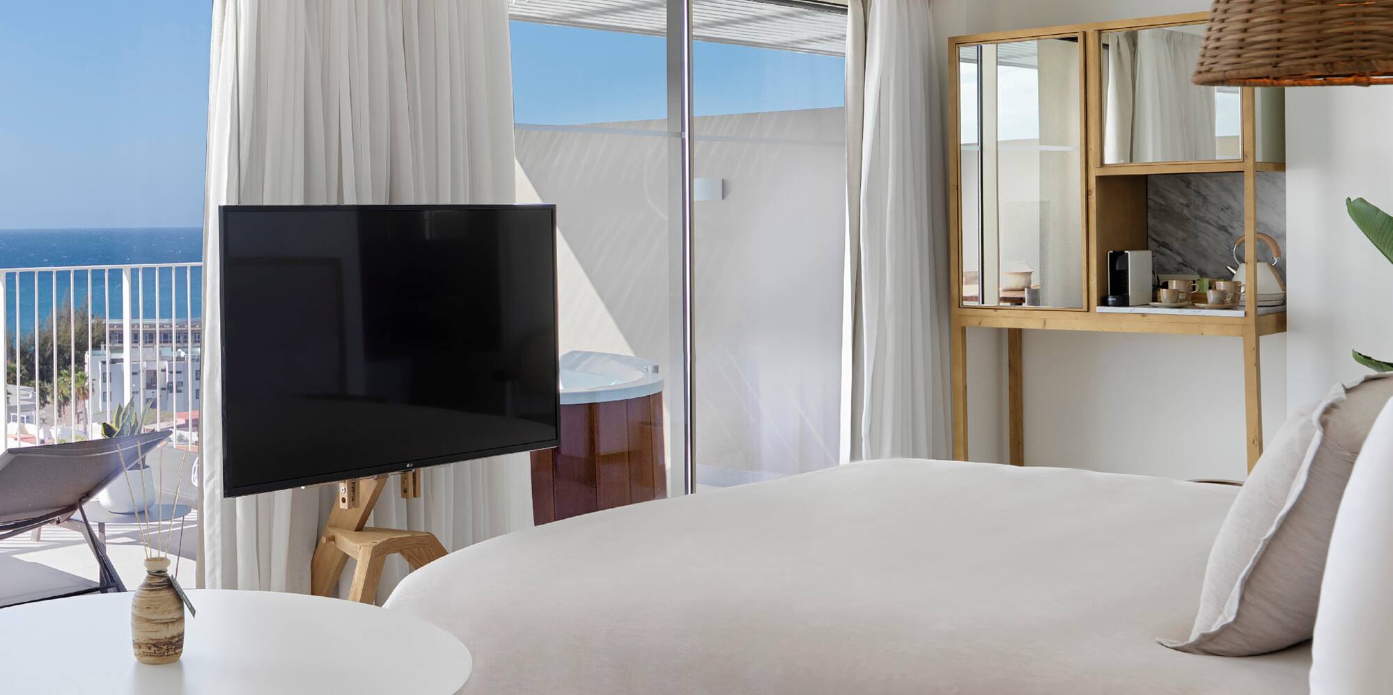 a bedroom with a television and a window