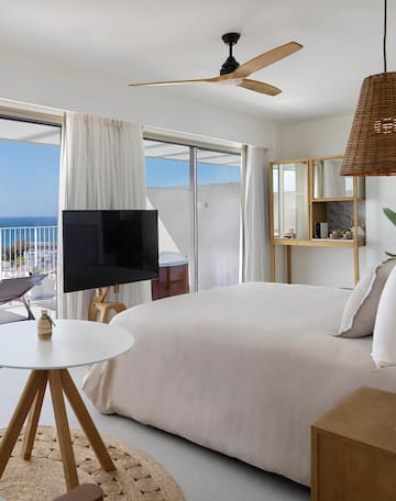 a bedroom with a television and a window