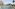 Resort water park pool with slides, lounge chairs, and tiered hotel architecture.