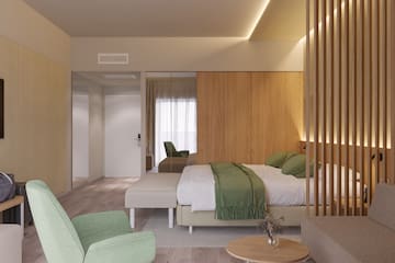 a bedroom with a bed and chairs