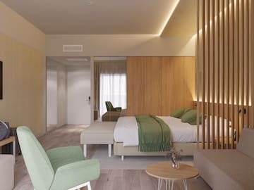 a bedroom with a bed and chairs