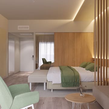 a bedroom with a bed and chairs