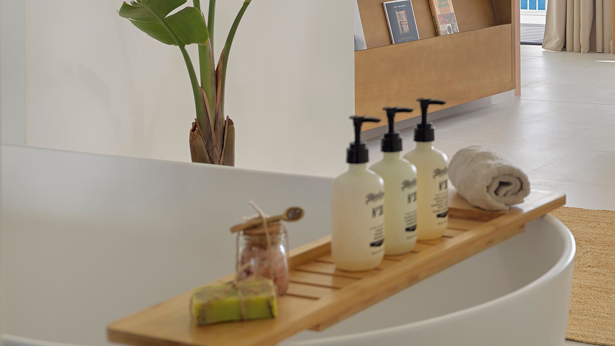 a bathtub with bottles of soap and a towel on it