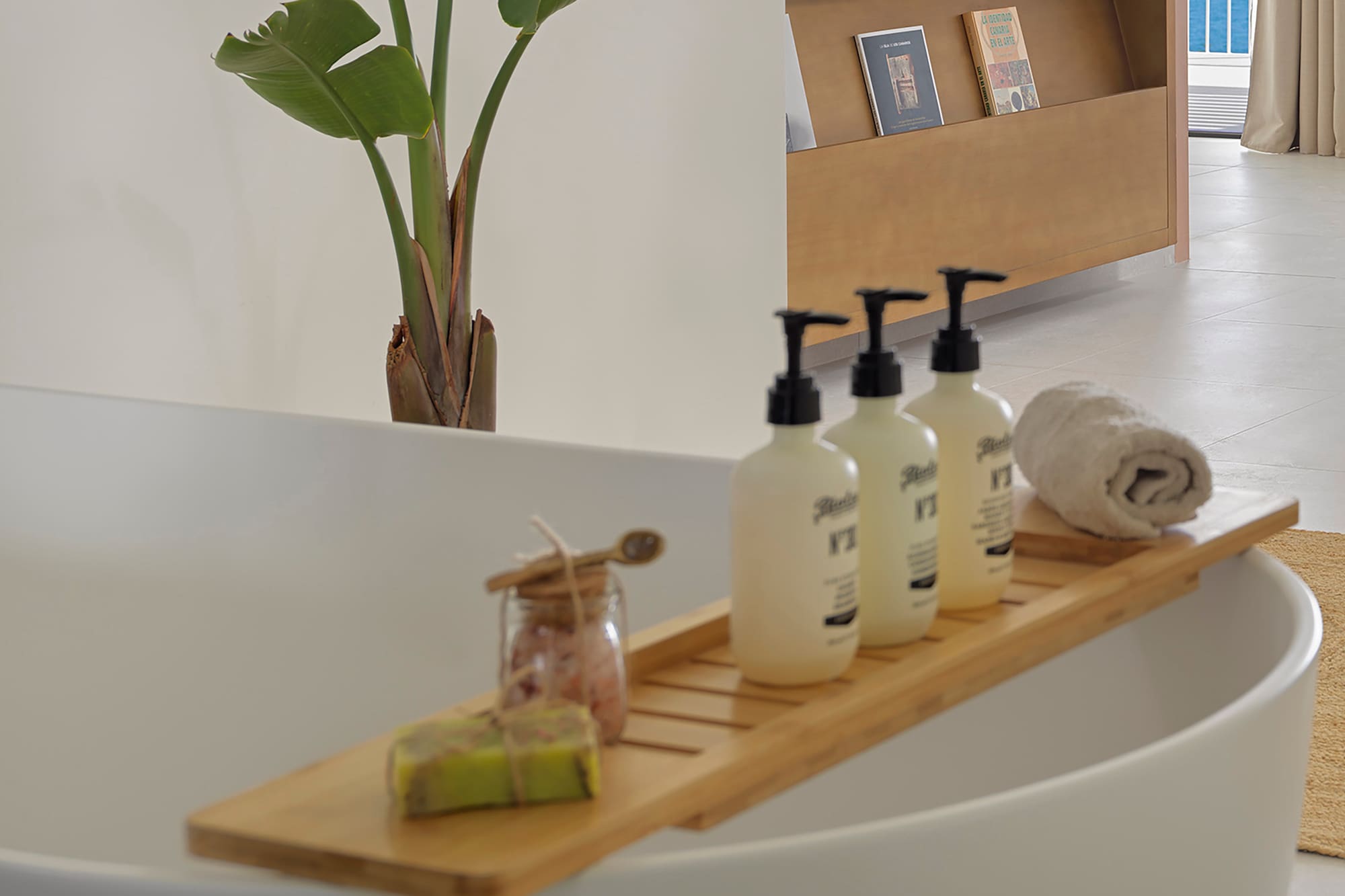 a bathtub with bottles of soap and a towel on it