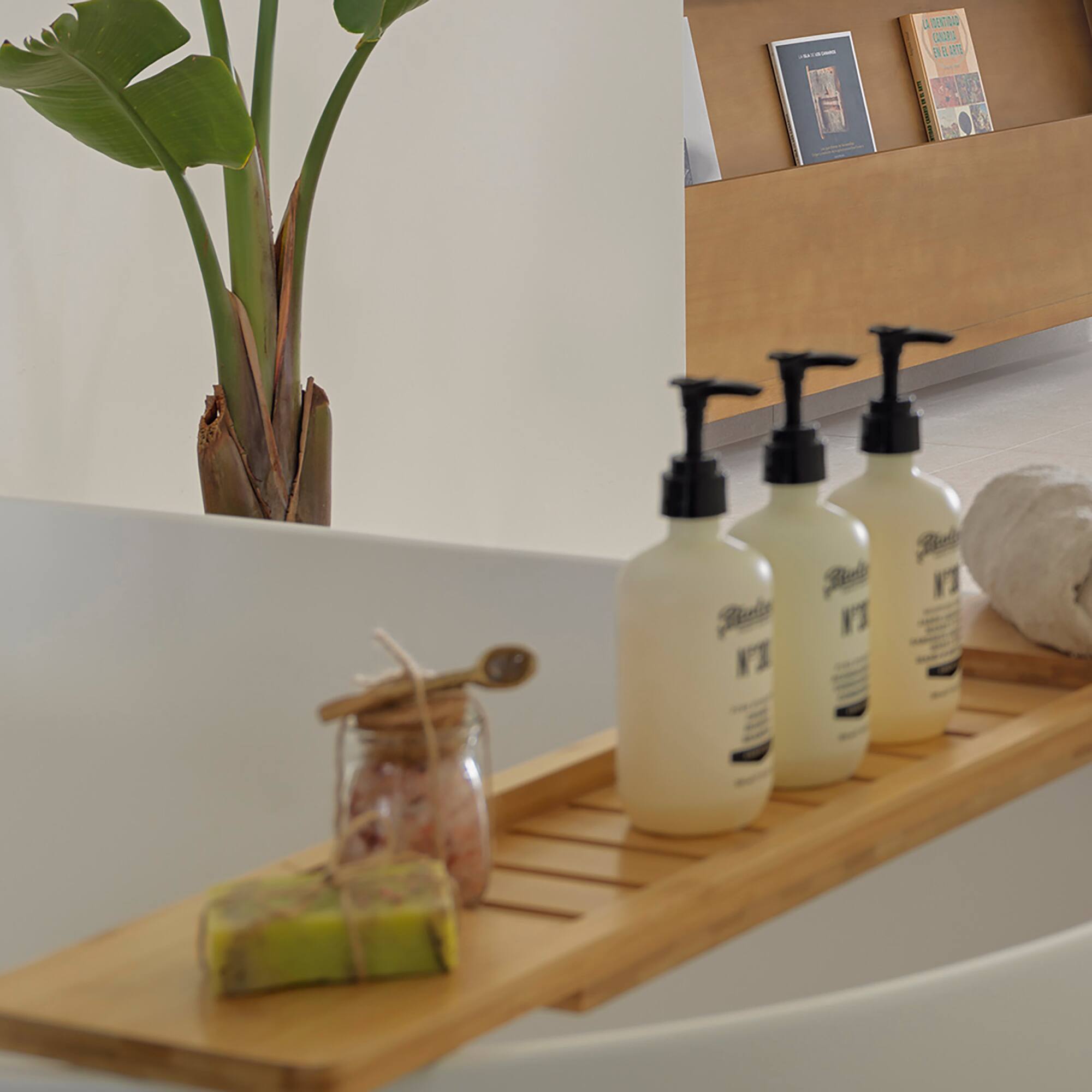 a bathtub with bottles of soap and a towel on it