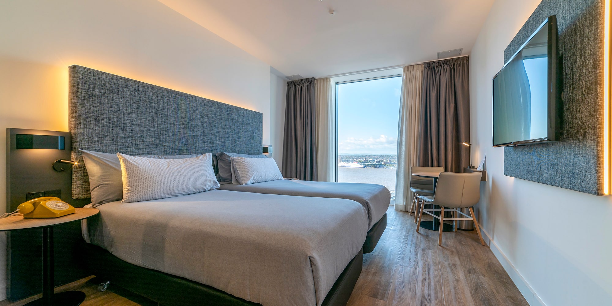 a room with two beds and a television