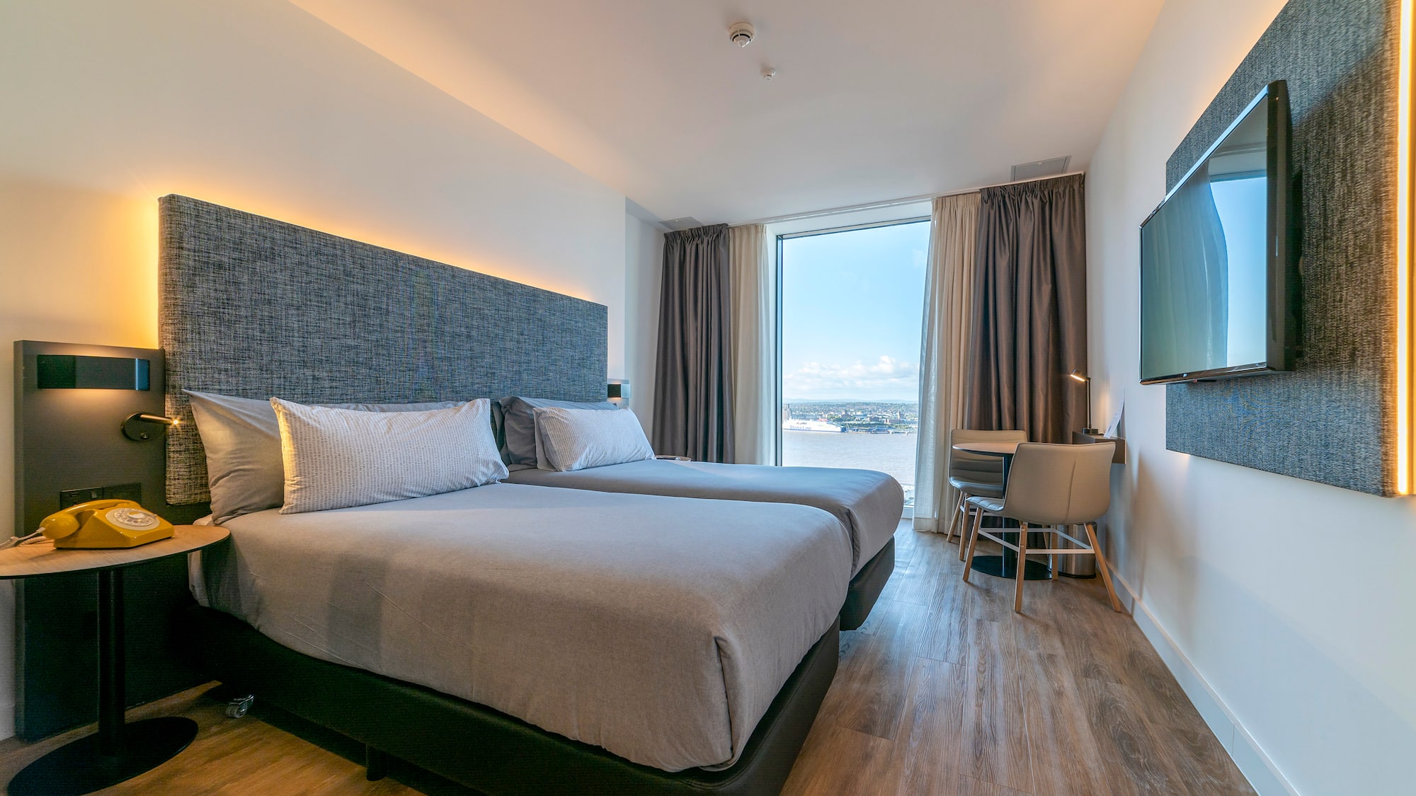 a room with two beds and a television