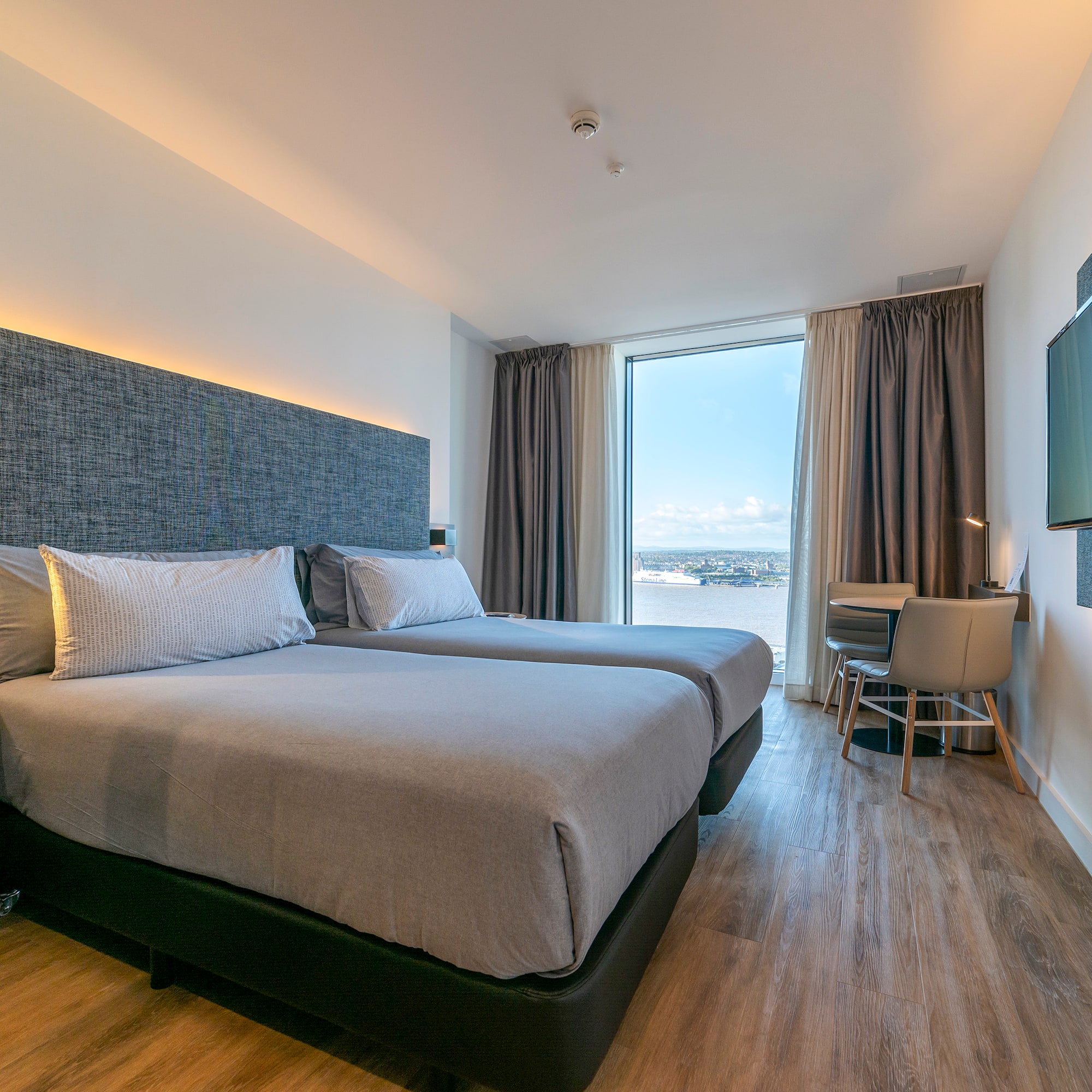 a room with two beds and a television