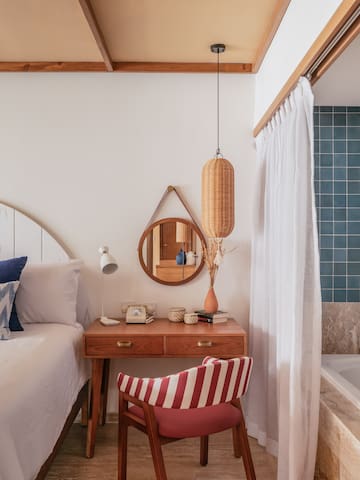 a bedroom with a bathtub and a bed