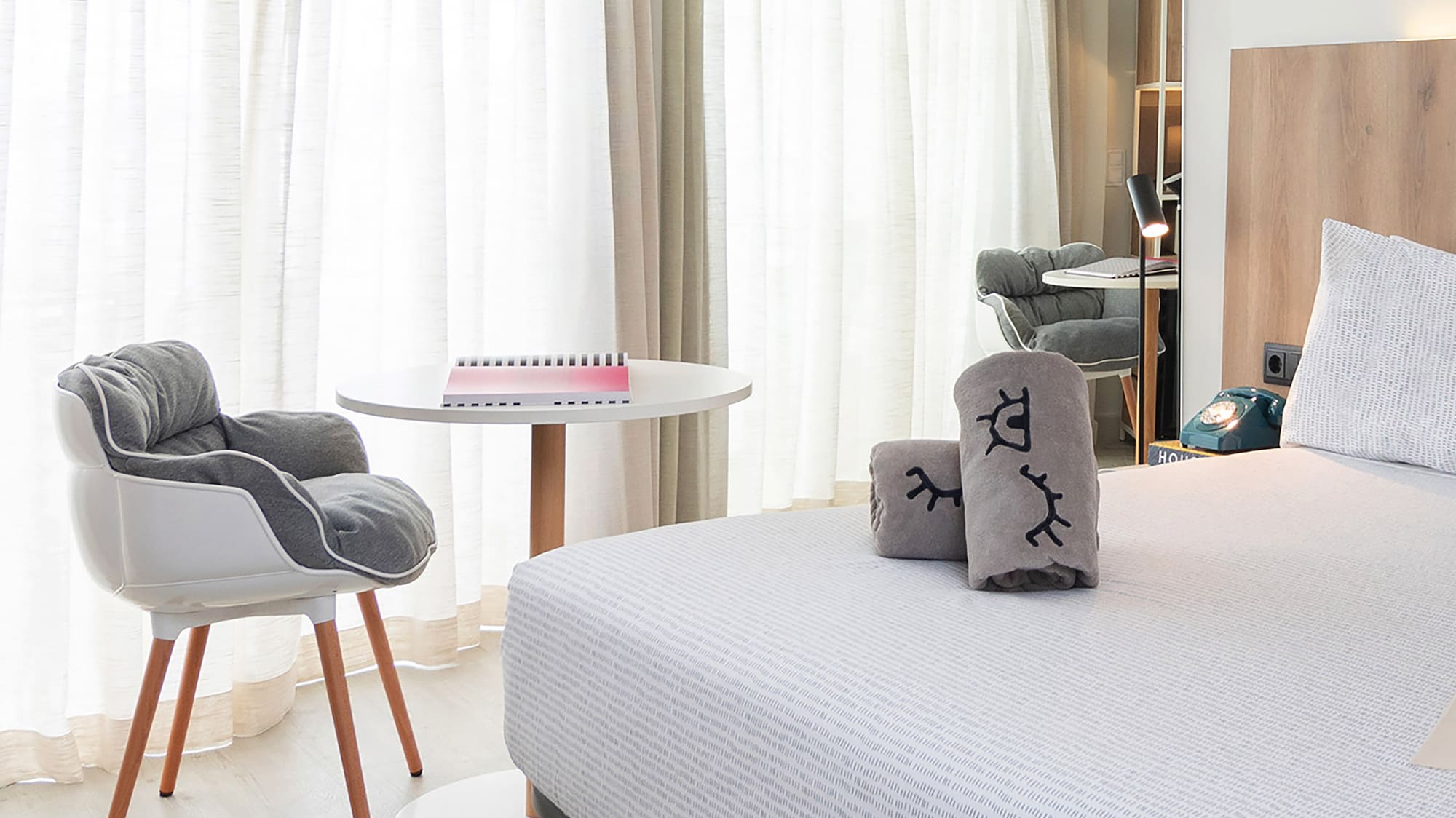 a bedroom with a bed and a chair