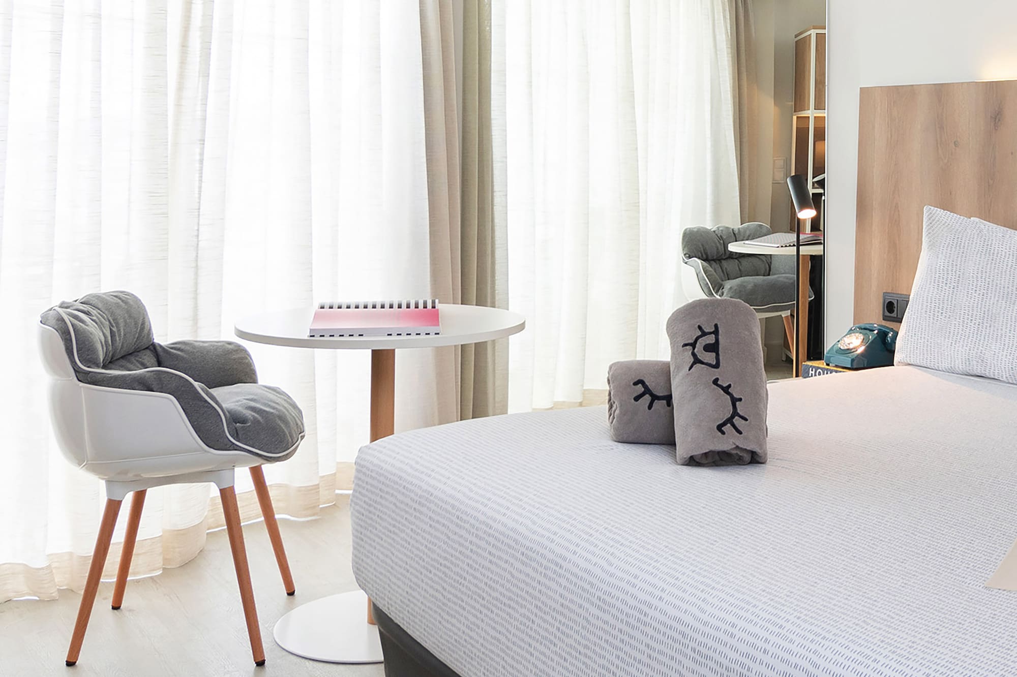 a bedroom with a bed and a chair