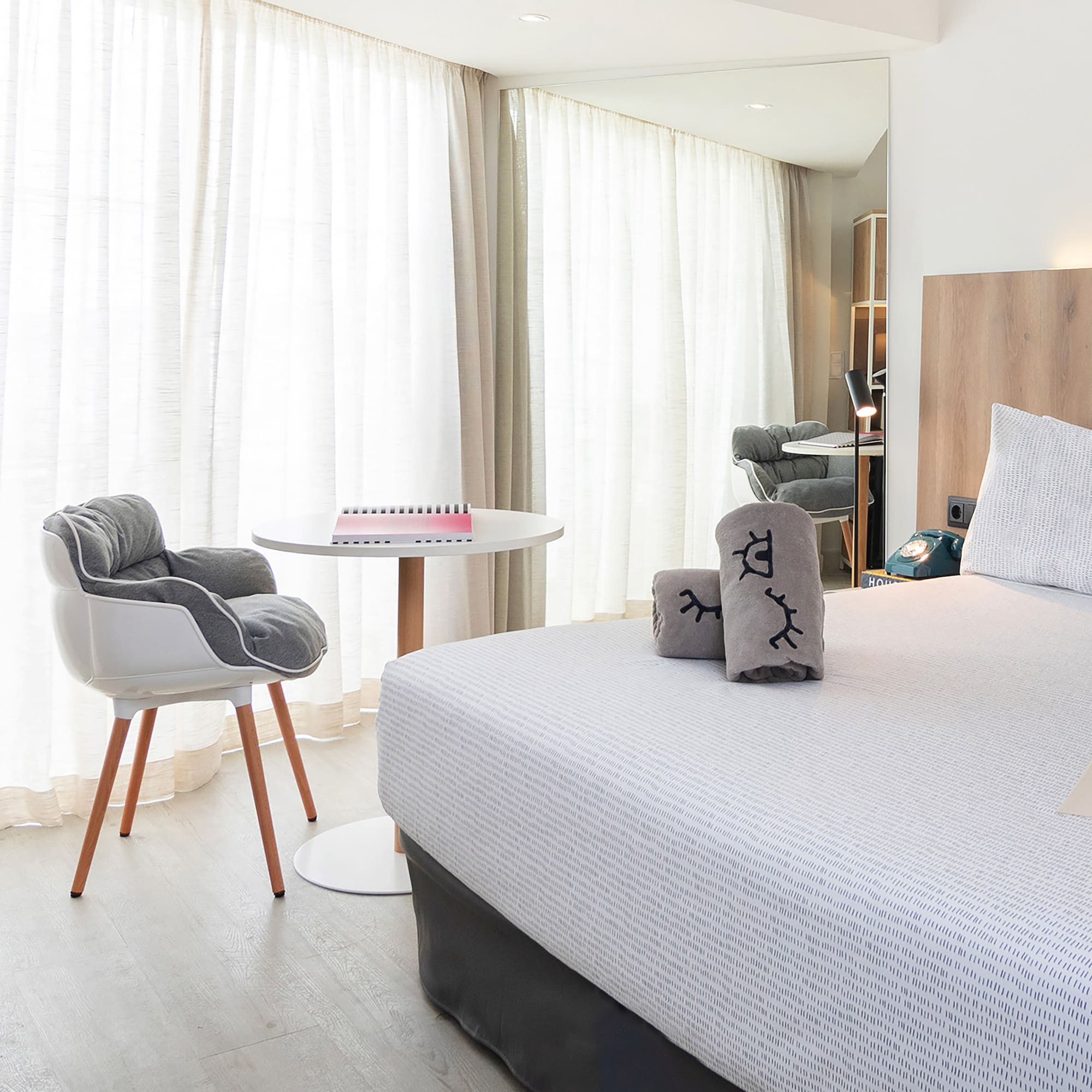 a bedroom with a bed and a chair