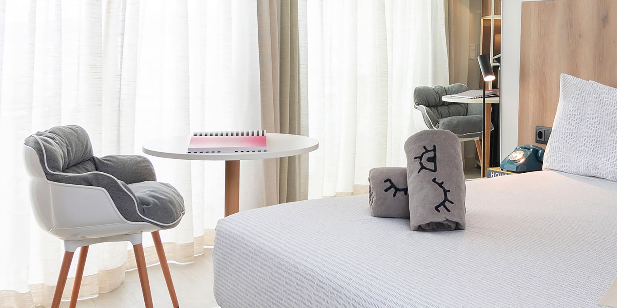 a bedroom with a bed and a chair