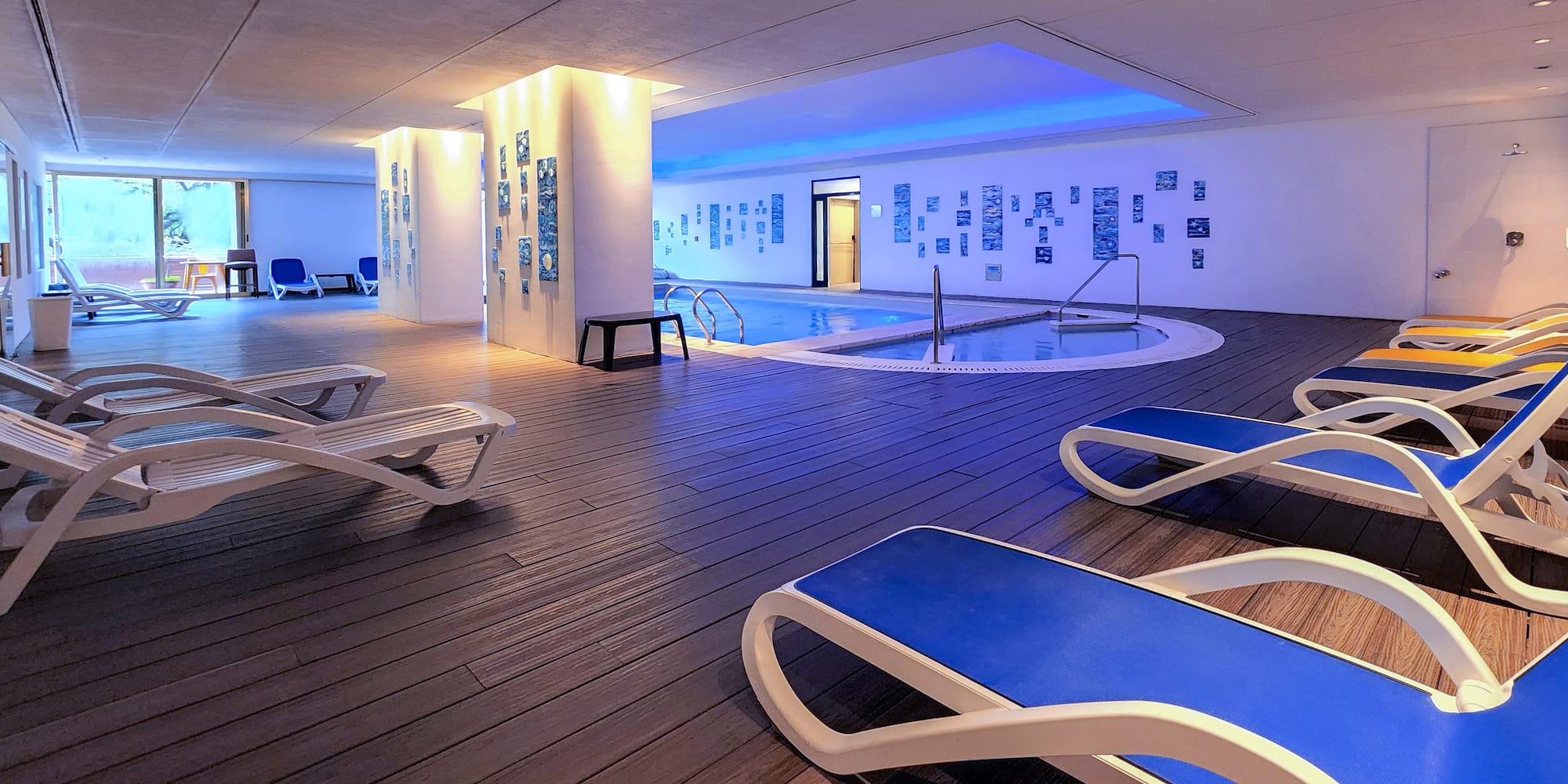 a pool with lounge chairs and a pool