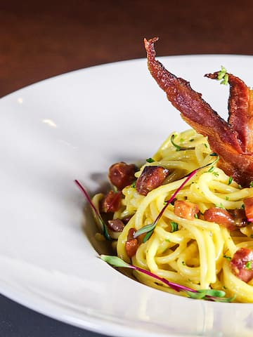 a plate of spaghetti with bacon