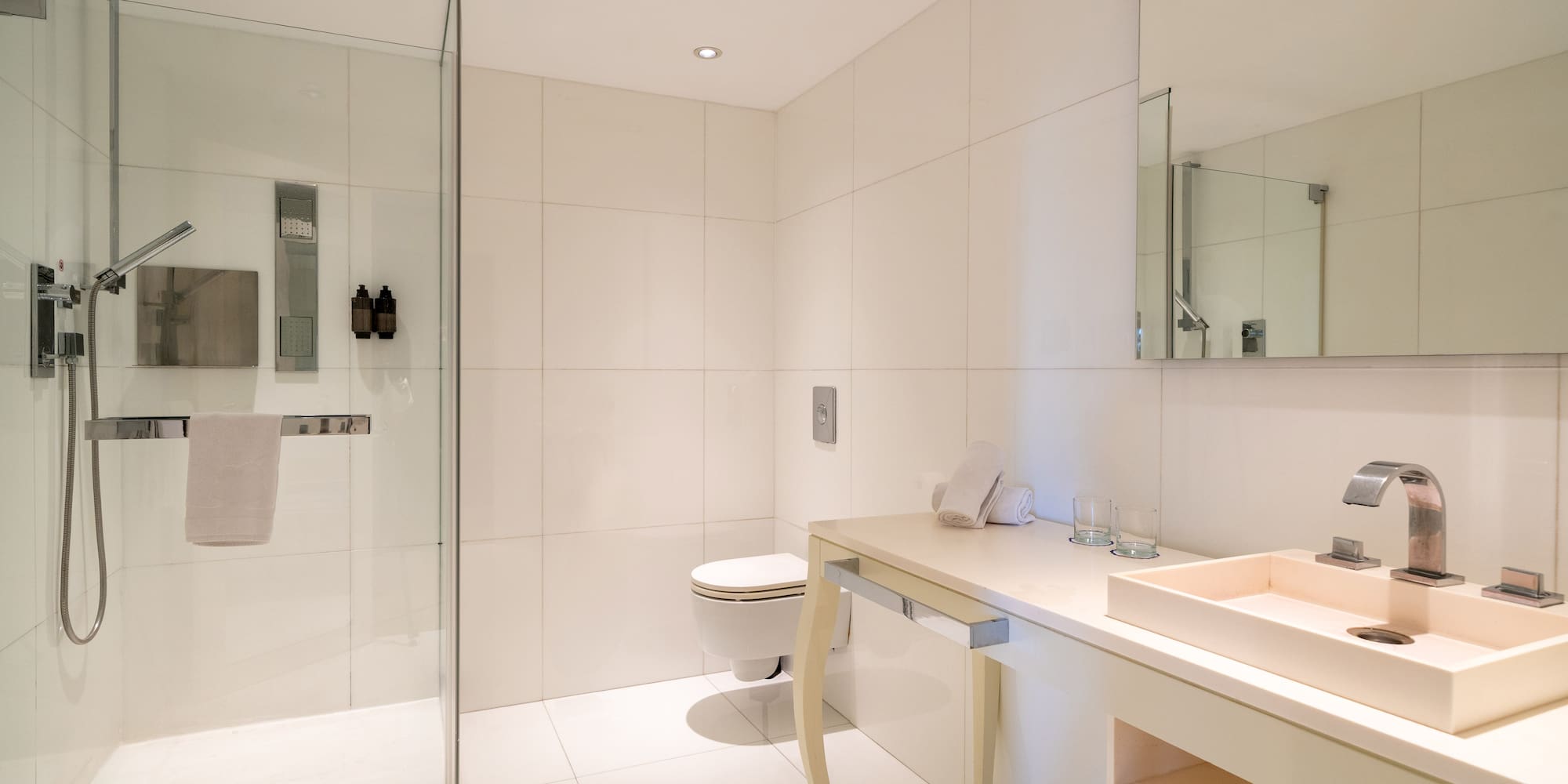 a bathroom with a glass shower and sink