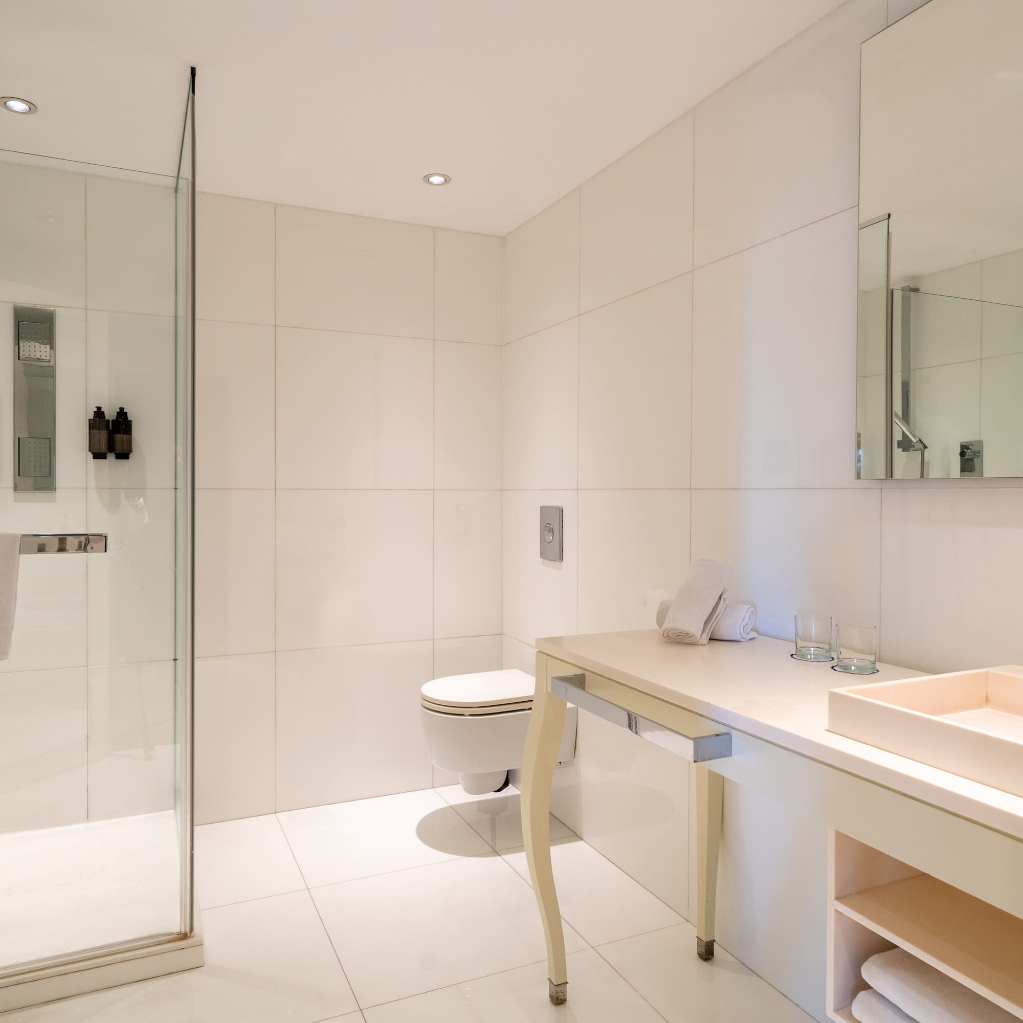 a bathroom with a glass shower and sink