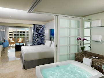a room with a jacuzzi and a bed