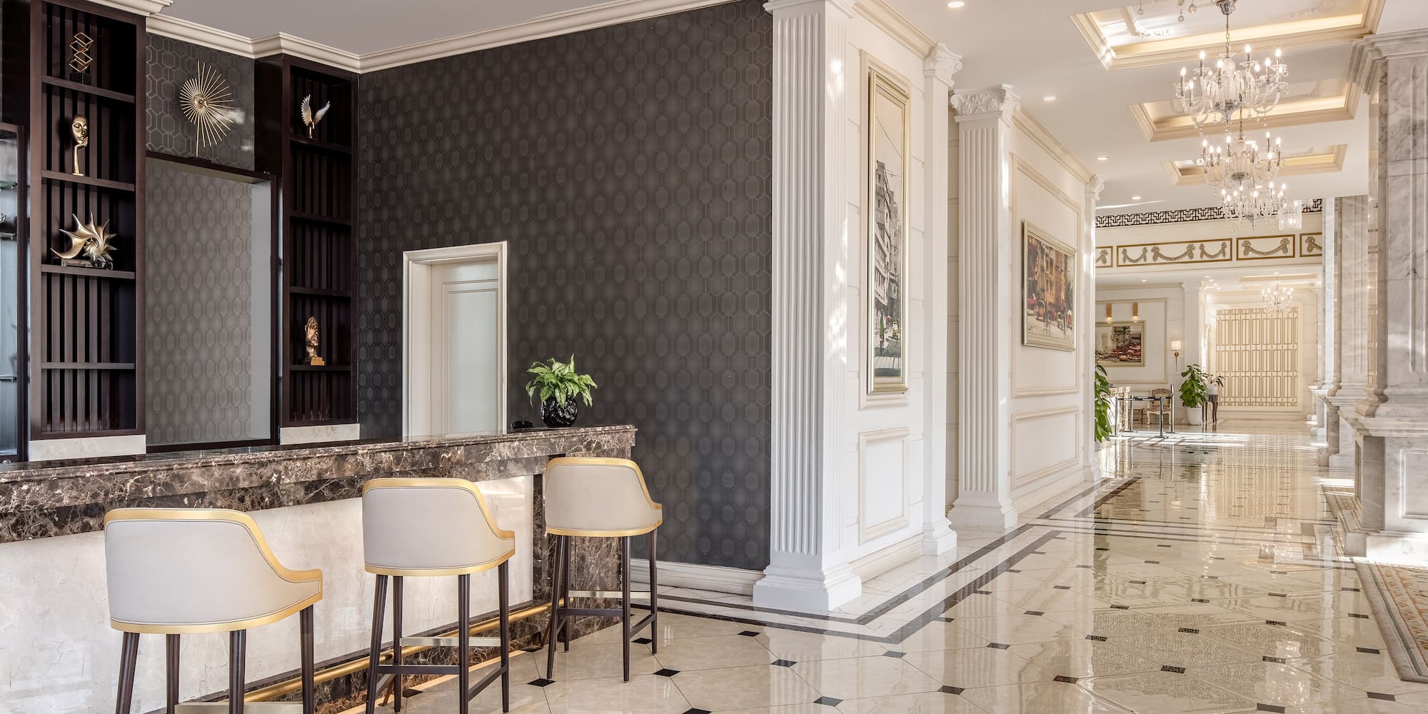 a lobby with a marble floor and chairs