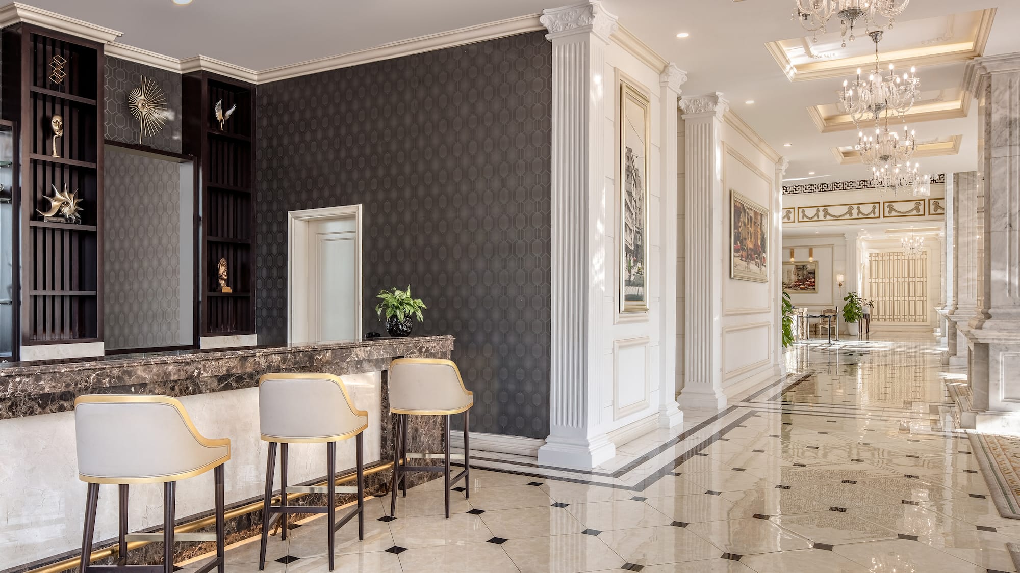 a lobby with a marble floor and chairs