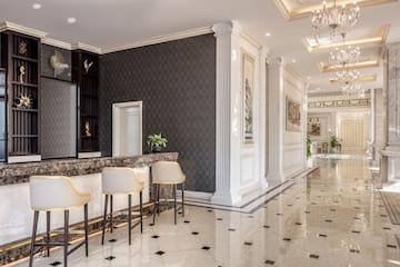 a lobby with a marble floor and chairs