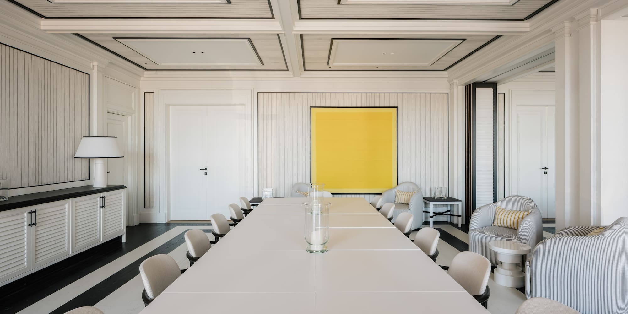 a room with a large table and chairs