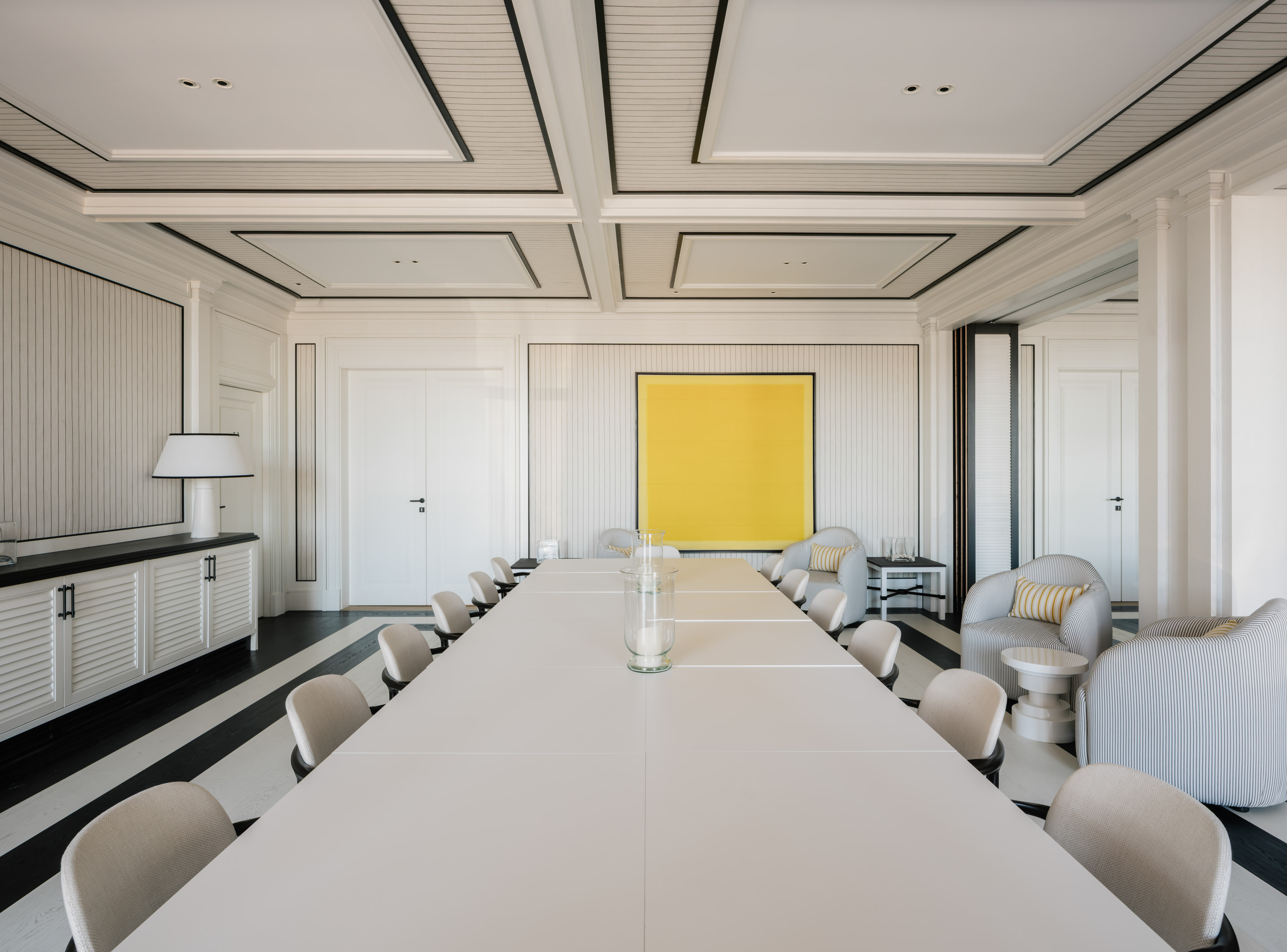 a room with a large table and chairs