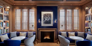 a room with blue walls and blue couches and a fireplace