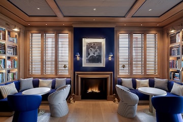 a room with blue walls and blue couches and a fireplace