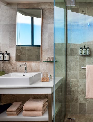 a bathroom with a glass shower and sink
