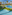 Sunny resort pools, palm trees, poolside bar, hotel, and ocean view.