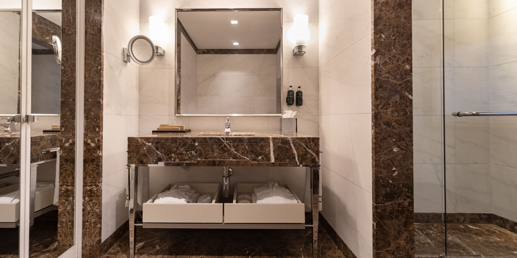 a bathroom with a marble countertop and a mirror