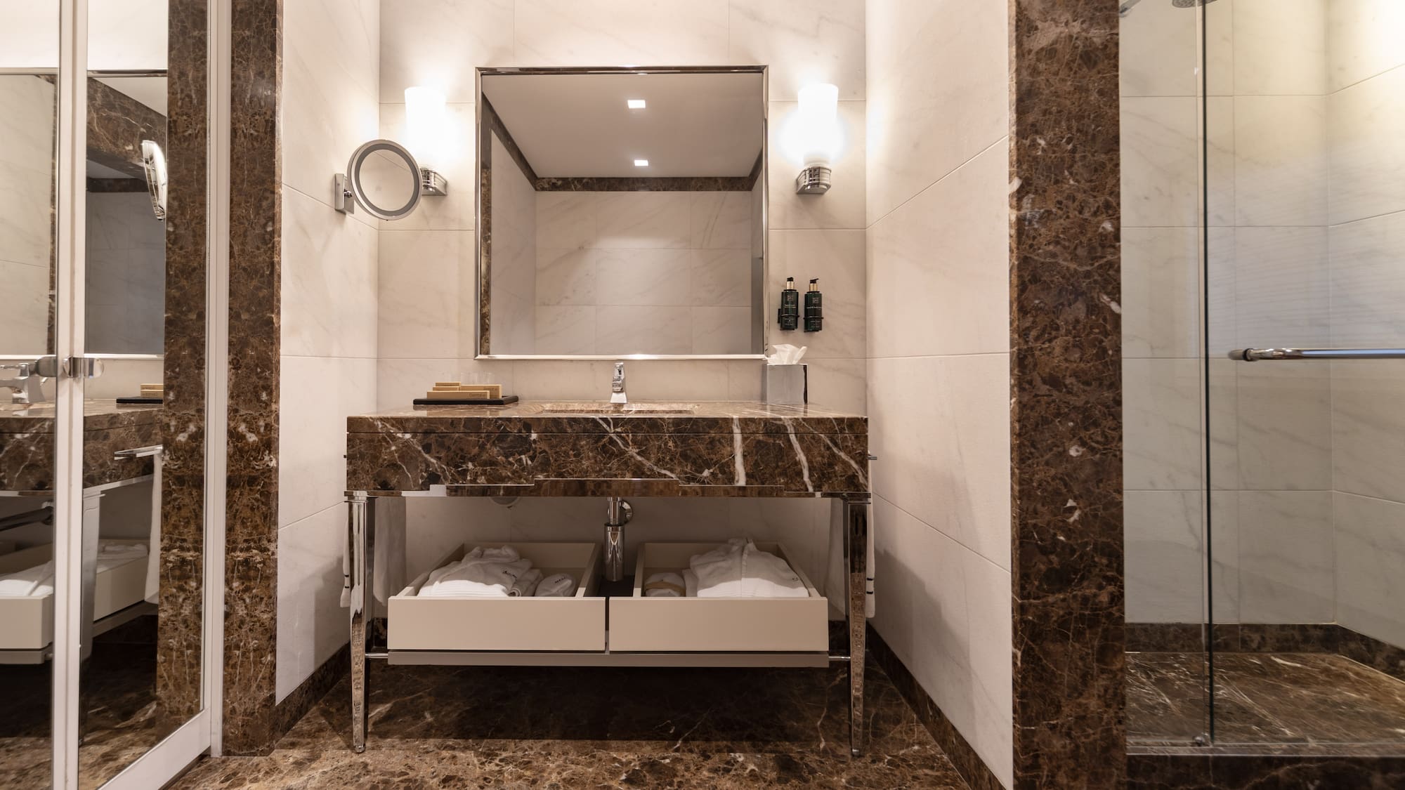 a bathroom with a marble countertop and a mirror